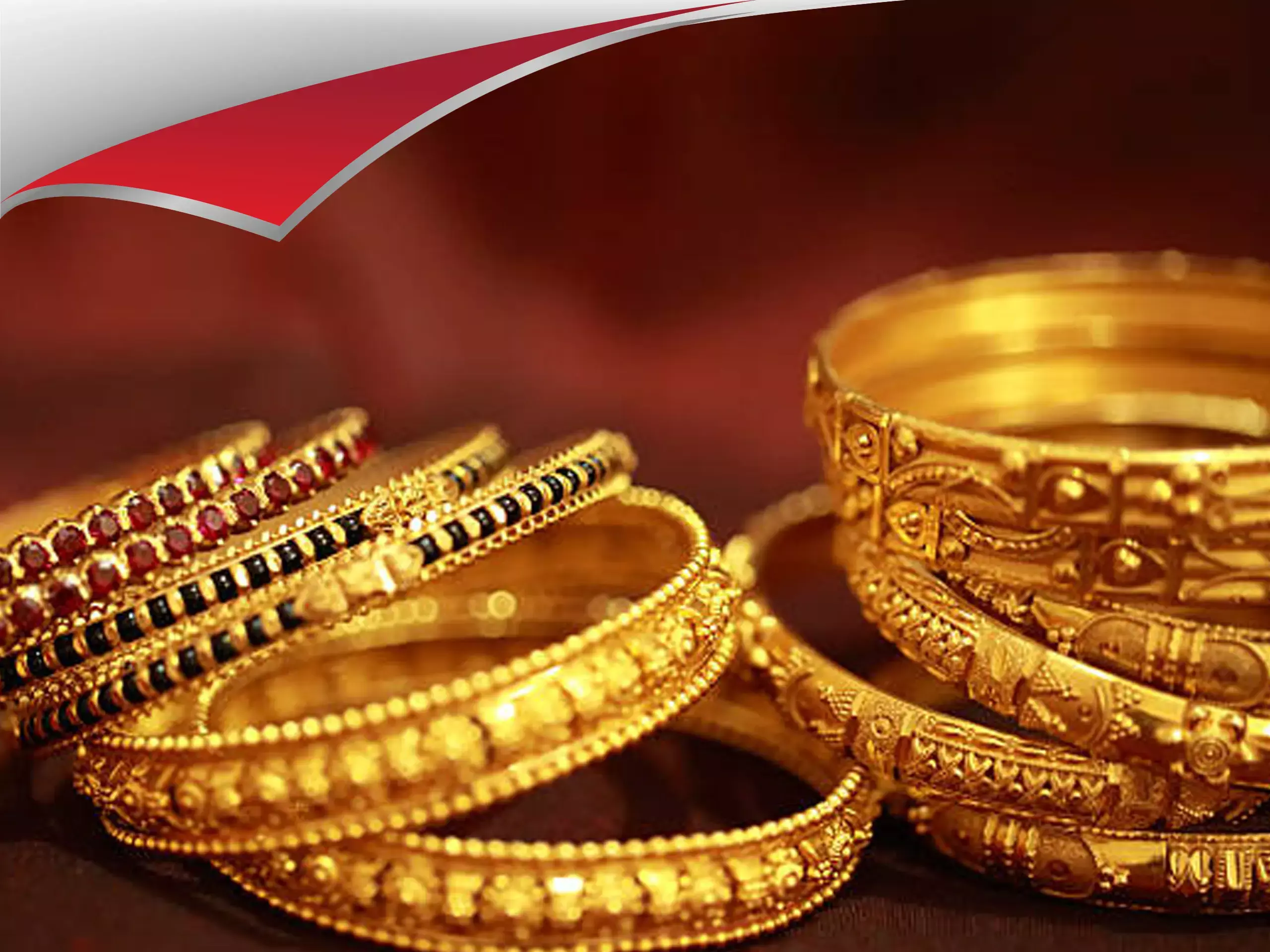 Gold bars and coins with a rising stock market graph in the background representing gold price hike.